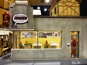 Modern miniature comic book store, side view.