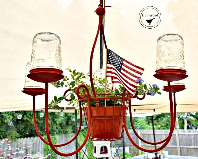 chandelier with red and mason jars and a plant