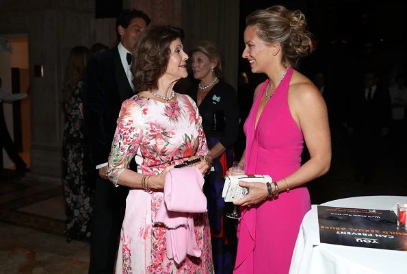 Princess Madeleine wore Giambatista ValliI floral print gown, and she carried Valentino Pink Rockstud clutch bag, Silvia wore a floral dress