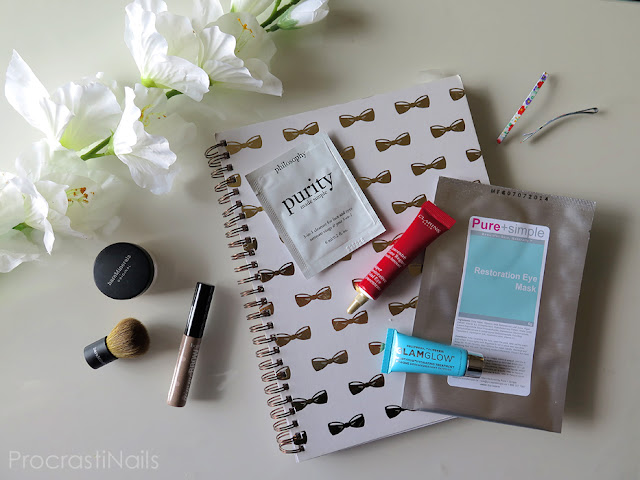 Beauty product samples pictured with a note book and flowers