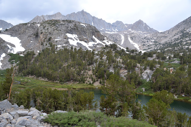 spire pieaks beyond hills and lake