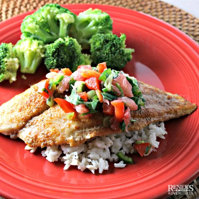 Sweet and Spicy Swai Fillets with Citrus Salsa on a red plate with rice and broccoli 