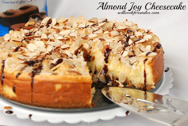 almond joy cheesecake with a slice missing and a pie spatula 