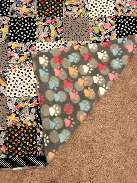 Paw prints on front and back of quilt.