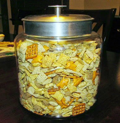 This dilly ranch snack mix is full of flavor and is perfectly munchable. It's a great grab and go snack or fun for a party. big glass jar filled with ranch snack mix