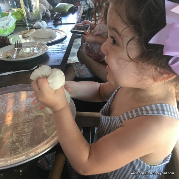 child playing with pizza dough at Dough Pizzeria Napoletana at Hemisfair in San Antonio, Texas child playing with pizza dough at Dough Pizzeria Napoletana at Hemisfair in San Antonio, Texas