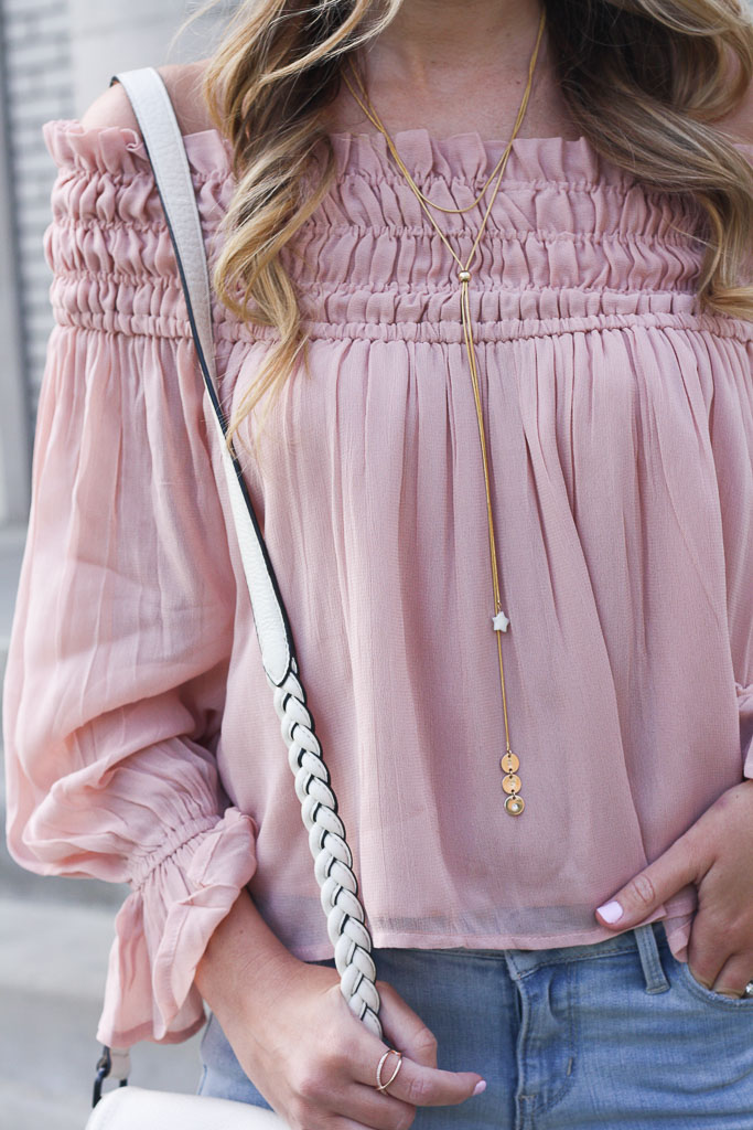 Pink off the shoulder top and distressed denim 