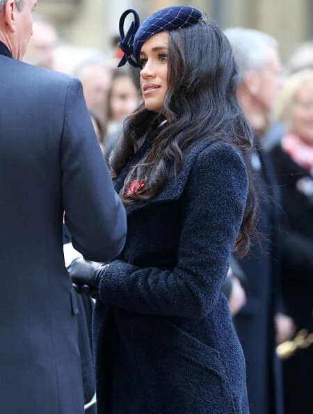 Meghan Markle wore Sentaler long wide collar wrap coat, Philip Treacy hat, Tamara Mellon boots. Royal British Legion traditional paper poppy