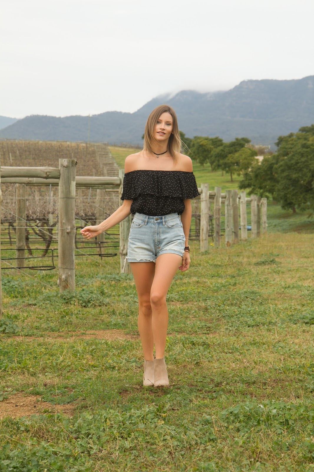 Fashion and travel blogger, Alison Hutchinson, is wearing a Topshop Bardot top, Ksubi denim shorts and Witchery beige ankle boots in the Hunter Valley, Australia