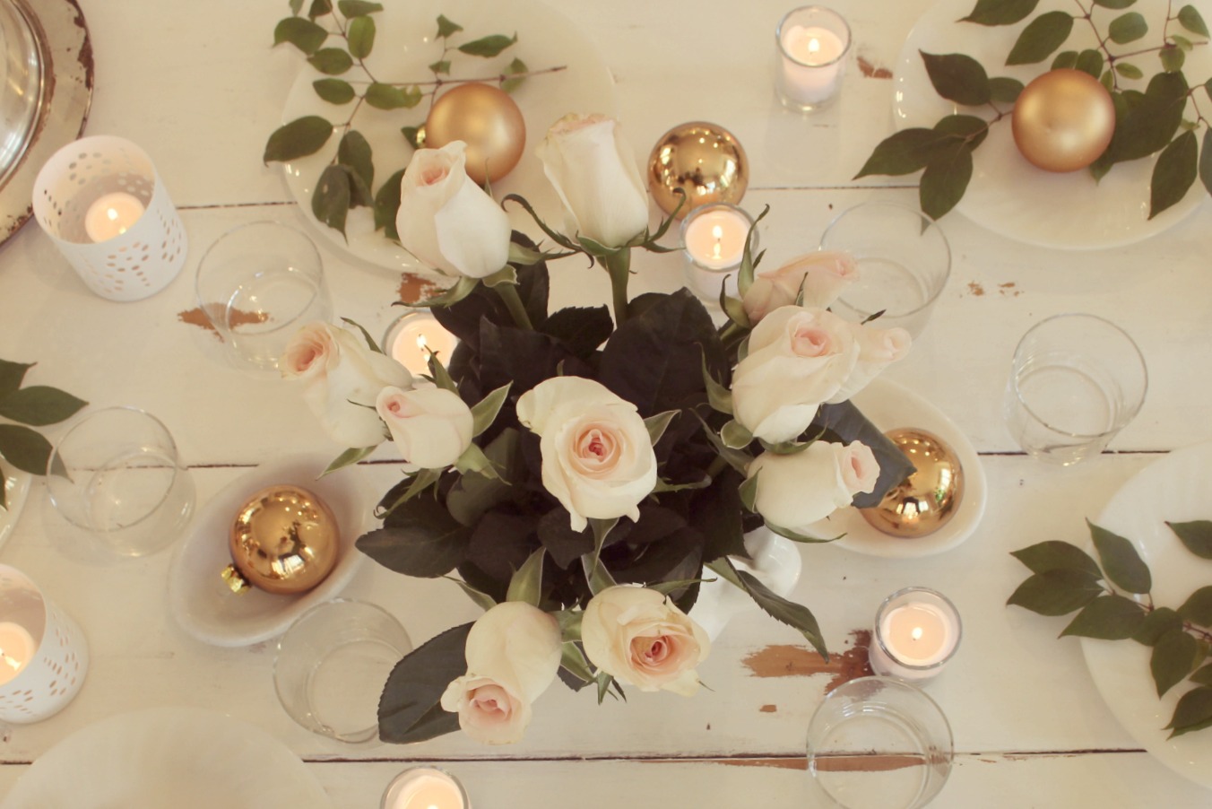 Romantic modern farmhouse feminine tablescape on white farmhouse table with blush roses gold and green