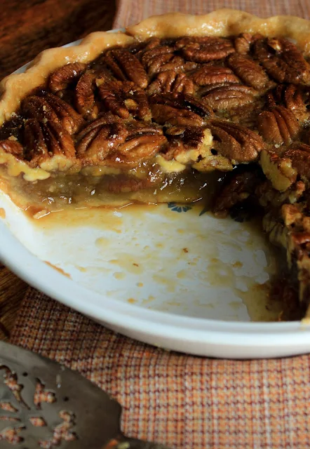 Maple Pecan Pie, a sweet, deep flavor of maple syrup complementing the richness of pecans in a classic pecan pie.  Perfect for any Thanksgiving meal!