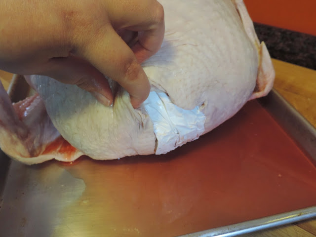 Demonstrating where the giblet bag is located in the turkey. 