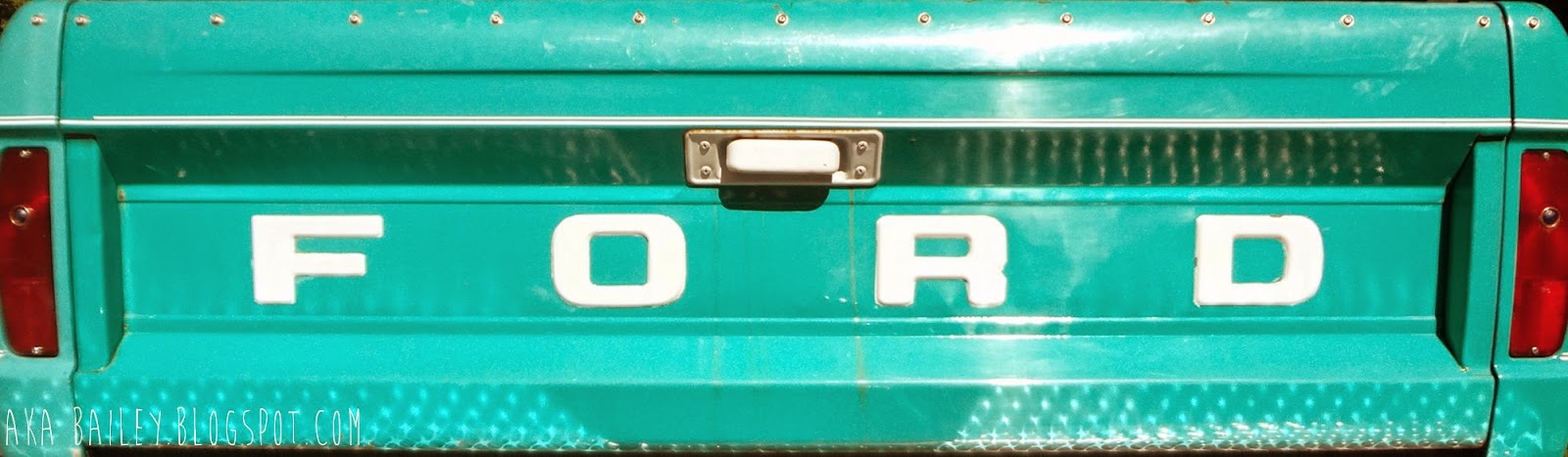 Tailgate of old turquoise Ford truck
