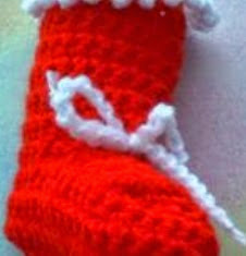 http://www.craftsy.com/pattern/crocheting/home-decor/mini-christmas-stocking/12690