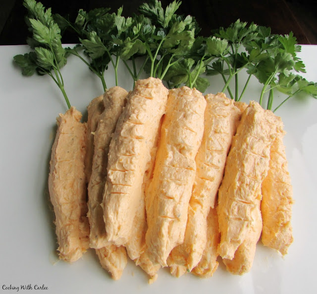 With just three ingredients and a few minutes you can have the cutest spring or Easter appetizer. The perfect cheese ball for a garden party too! carrot shaped cheese balls with parsley toppers