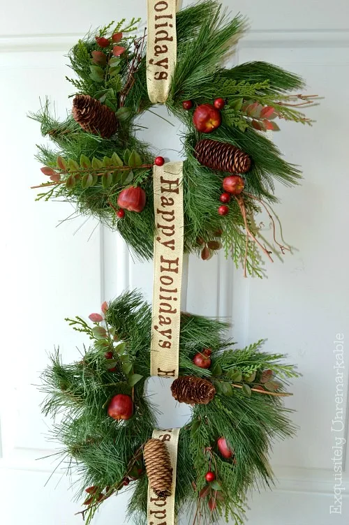 Part of a Christmas triple wreath on a white door