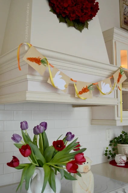 Kitchen decorated for Easter with tulips and a DIY banner
