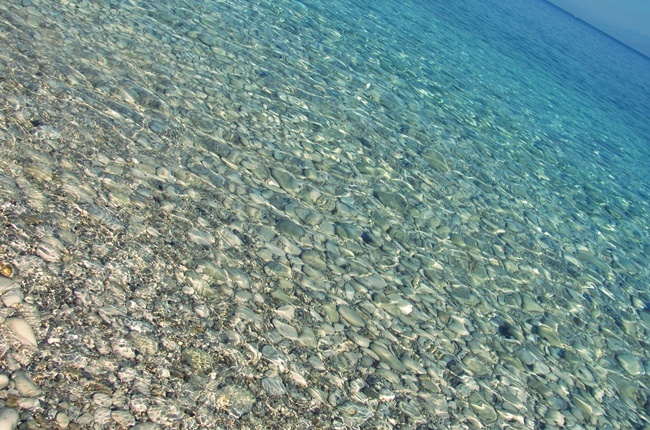 Corfu beaches with pebble rock and stones