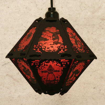 This limited edition paper lantern by Bindlegrim features red & black Halloween imagery