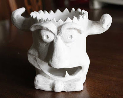 monster face sculpture unglazed