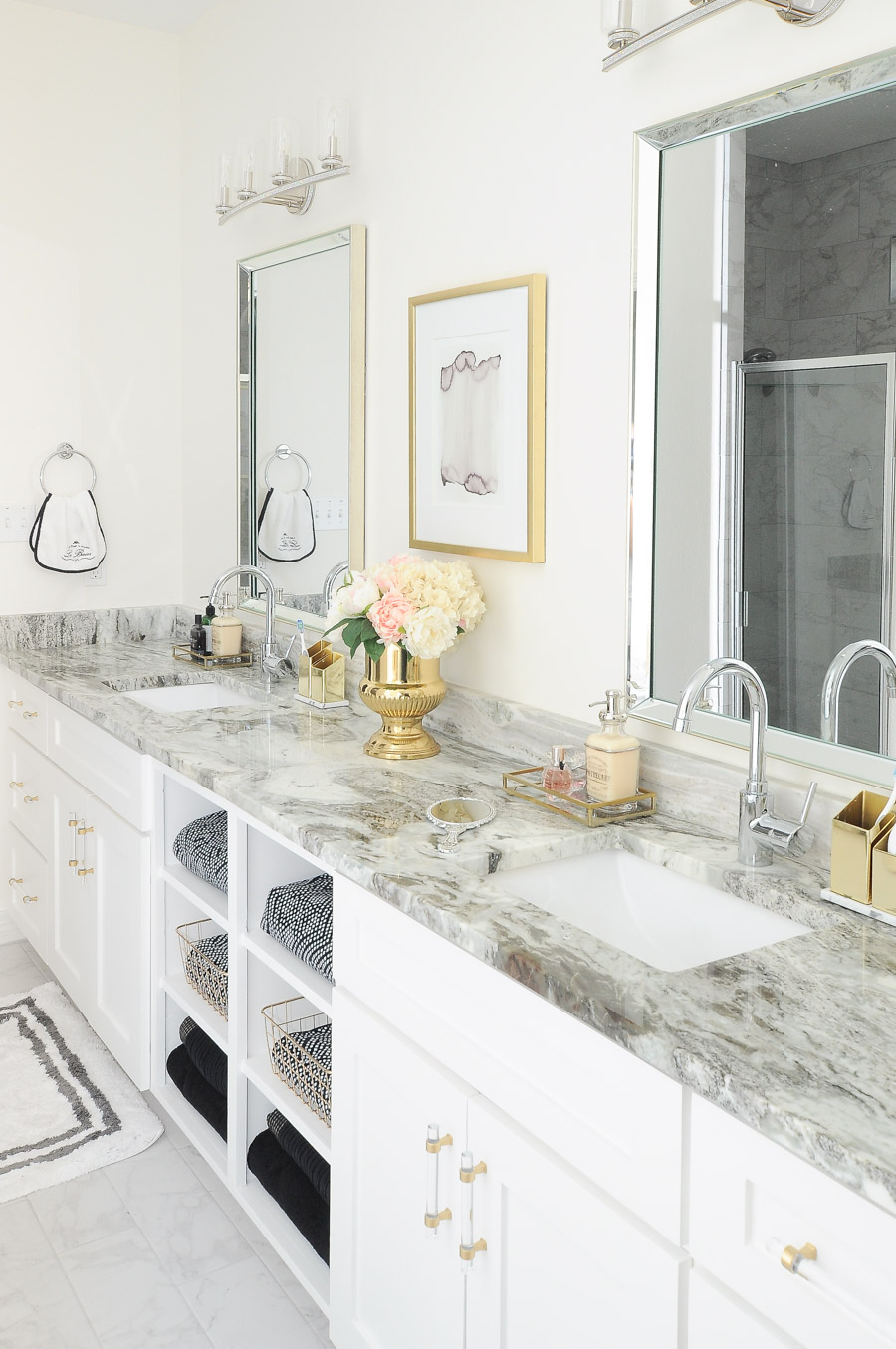 Regrets from our new construction home in Corpus Christi A white master bathroom with gold lucite cabinet pulls, alabaster walls, fantasy brown granite and a luxe vibe. | #bathroom #bathroomdesign #masterbathroom