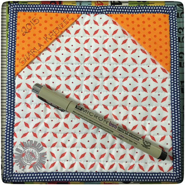 Hanging triangles on a Mini Mini Quilt Back by Thistle Thicket Studio. www.thistlethicketstudio.com