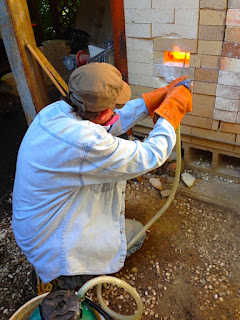 Future Relics Pottery adding soda ash into a kiln