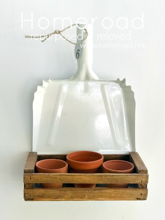Dustpan planter filled with terracotta pots