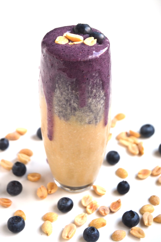 Peanut Butter and Jelly Smoothie looks beautiful in a glass with separate layers that taste like grape jelly and peanut butter! Use your choice of berries for different options. www.nutritionistreviews.com