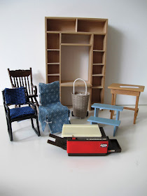Various one-twelfth scale furniture items, including chairs, a desk unit, a side table, a wicker shopping trolley and a photocopier.