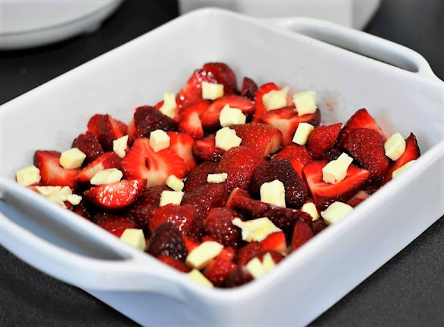 Assembling Strawberry Cobbler in Baking Dish Image
