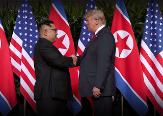 This is indeed a momentous time. Today, we'll all set aside disagreements to celebrate what is clearly best for all of us: peace. image of USA president Donald Trump and North Korea Supreme Leader Kim Jong Un shaking hands in front of many USA and North Korean flags