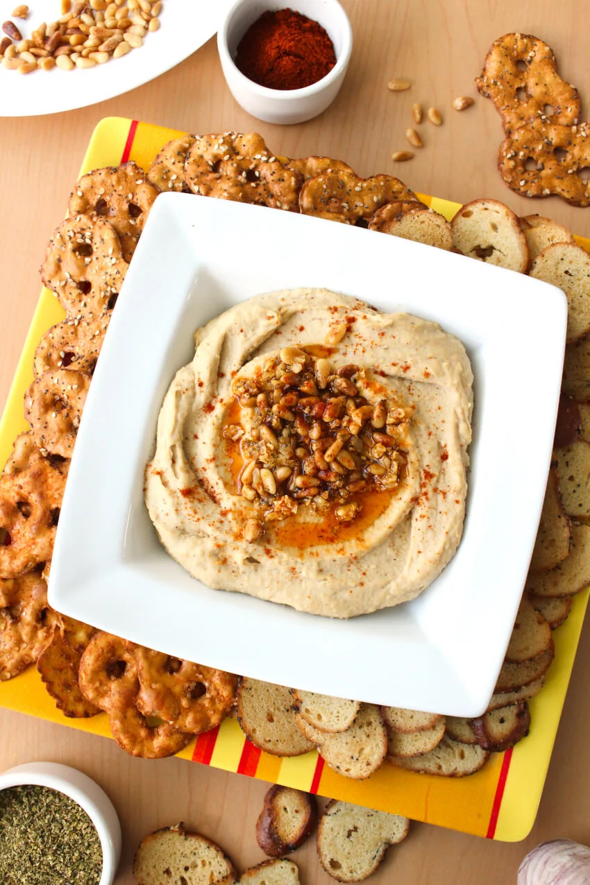 Toasted Pine Nut Hummus is so easy to make at home, you will never want to buy it at the store again. It is perfect to serve as an appetizer, in your lunchbox, or as an after school snack! #hummus #appetizer #diprecipe