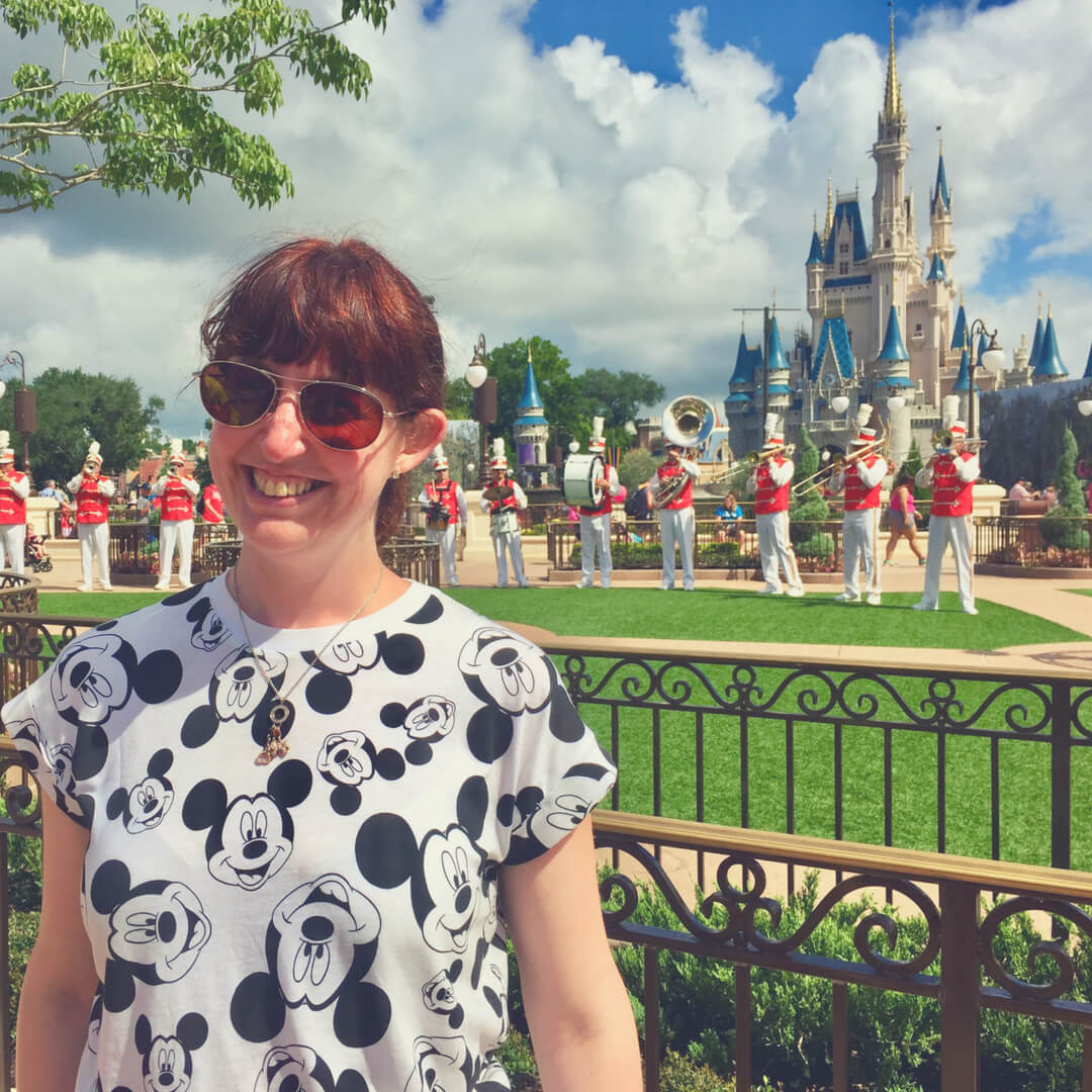 Morgan Prince standing in front of Cinderella's Castle at Magic Kingdom, Walt Disney World while a big band plays music.