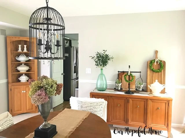 farmhouse dining room sideboard ironstone demijohn olive branches balance scale olive buckets cutting boards boxwood wreaths