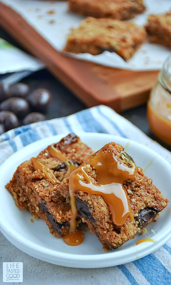Homemade Chocolate Caramel Bars | by Life Tastes Good have a buttery, brown sugar and oats crust that tastes like the best oatmeal cookie in the entire world, topped with luscious dark chocolate and whole roasted almonds in a creamy caramel sauce under a crumbly streusel topping. Take a moment to savor that thought...