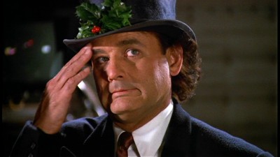 Bill Murray in a holiday hat in Scrooged 1988 movieloversreviews.filminspector.com
