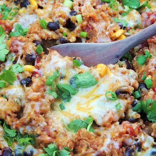 Slow Cooker Chicken Enchilada Quinoa in the crockpot with a spoon.