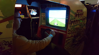 Having a nice sit down to play Pole Position Pole Position at Arcade Club in Bury