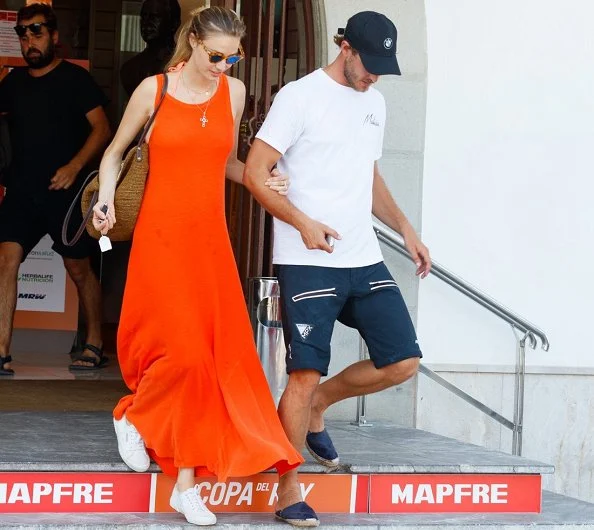 Pierre Casiraghi and Beatrice Borromeo in Palma de Mallorca. Beatrice Borromeo wearing a orange maxi dress