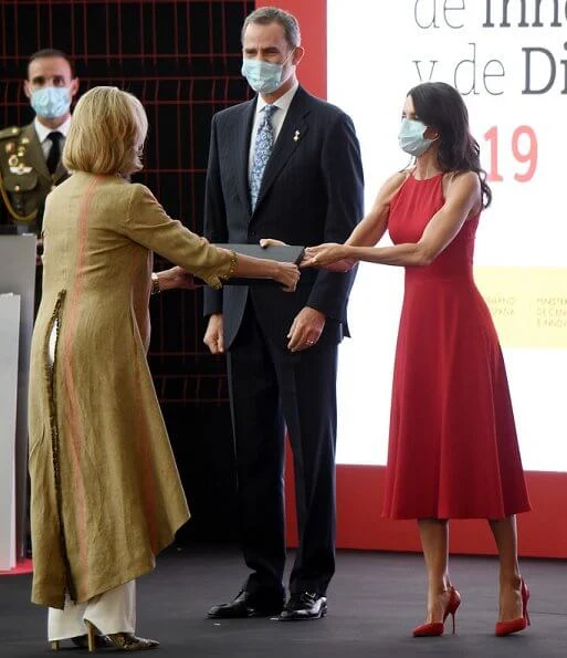 Queen Letizia wore a halter neckline red dress by Carolina Herrera, and nude patent leather slingback pumps, and animal print clutch