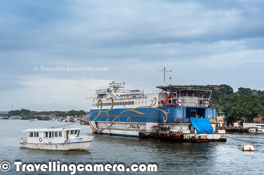 Taking a cruise on Mandovi river and experiencing the dynamic city Panajim by water is considered as one of the must do thing in Goa. Although options available during Monsoons are comparatively lesser. But still we thought of taking a cruise on Santa Monica, which is managed by Goa Tourism Department. This Photo Journey shares some moments from this cruise experience and more details on various options available in and around Goa.The Goa Tourism Development Corporation (GTDC) runs a variety of river cruises on the Mandovi river during daytime, sunset and moonlight. There are two types of day cruises which start from the Panaji jetty, down the Mandovi into the Zuari bay and up the Mandovi to Aldona and a mineral water spring. There are few private firms who also offer a variety of imaginative cruises or boat tours for sunset views as well as for crocodile or dolphin spotting. but we found is hard to identify these options during monsoons. Many of the folks gave us the reason that it's risky during monsoons to go deep into the sea, while we noticed many of the fishermen boats at a distance. Most probably, it's related to business reasons & low tourist inflow during monsoons.We opted for evening cruise from Goa Tourism office which is near to Mandovi river bridge which connects North Goa to it's southern part & Panjim. Santa Monica is considered as a pride of Goa Tourism Development. This is used for daily evening cruises on river Mandovi with 'live' cultural programs performed by the best cultural troupes of Goa. Usually one cruise duration is 1 to 1.5 hrs and it takes multiple rounds in evening. Ticket was 200 Rs per person which quite cheap. Santa Monica has huge capacity so Goa Tourist makes enough money. And don't miss the video of a gentleman dancing at the cruise :) . It's placed in the bottom of this postAt any point of time Santa Monica can accommodate approximately 200 guests. Inside the cruise, there is usually a bar counter which also serves very basic snacks, but not very exciting affair. very badly managed and crowd makes it worse. So we didn't even try to go near it. And fortunately it was just one hour. Santa Monica is also available for special parties on hourly basis and it seems, many folks book it for weddings as well. The Santa Monica cruise is the most attractive entertainment with live Goan Cultural Show and music on board. We loved this the most. There were some Goan performances by very sweet performers on the cruise. These performances keep you busy most of the time and you need to put efforts in taking out your attention & view other things around the river.As ride starts, it moves across the riverside with beautiful views of Panjim town. Then it moves towards the other and goes deep into the river. Various ships and steamers come on the way and many of the ships are used for local transportation. Many folks use these ships to cross river with their vehicles.There are different types of cruises available in Goa. Sunset Cruise one of the famous one which departs at 6.00 pm for one hour. The other one which starts at 7:15pm is known as Sundown Cruise. There is a special cruise called as Full Moon Cruise, which starts at 8:30pm & it's for 2 hours.  'Dolphin Fantasy Cruise' sounds very interesting :) . This cruise is only available on Mondays, during mornings. I guess, for 2 hours. Idea is to watch the dark graceful water beauties in a playful mood and the rhythmic dance of love - yes we are talking about Dolphins in Goa. This cruise helps in sighting closely the head lands jutting out into the sea, the Raj Bhavan, Aguada Fort & Reis Magos. There is another cruise offered by Goa Tourism - 'Pearl of the Orient'. I loved these names :) ... This is an interesting cruise with walking experience which helps in exploring natural & cultural heritage by visiting World Heritage Monuments at old Goa. We were not aware of this option when we visited Goa, otherwise this would have been our first option. This happens only during Saturdays and timings are from 9:30am to 1pm.If you want to experience Backwater Thrills cruise, plan your visit between Tuesday & Friday. Weekenders would miss this. This starts at 9:30am and ends at 4pm. It's about cruising along the riverine tip of Islands of Chorao, Divar, Old Goa. This cruise is very interesting for endless sights and sounds of Mandovi’s thick mangroves. Cruise offers the experience of typical Goan cuisine served in earthen pots and banana leaf. It seems that Goa tourism also arranges special cruises for longer periods of time. Panaji jetty ticket counter is best place to find out more details about cruise options in Goa.Cruising around Goa is a fun activity and Goa Tourism department really does a very good job in managing these cruises very well with great flavor of goan culture and music. It's real fun to enjoy goan music on cruise with awesome performers. Most of the times, they also play music for guests, if they want to dance in the middle of the river :). If you plan for the cruise in Goa, be prepared for the long waiting queues and I am sure that wait would be more during the season. But it's all worthwhile.