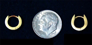 Photo comparing a lost earring with a dime