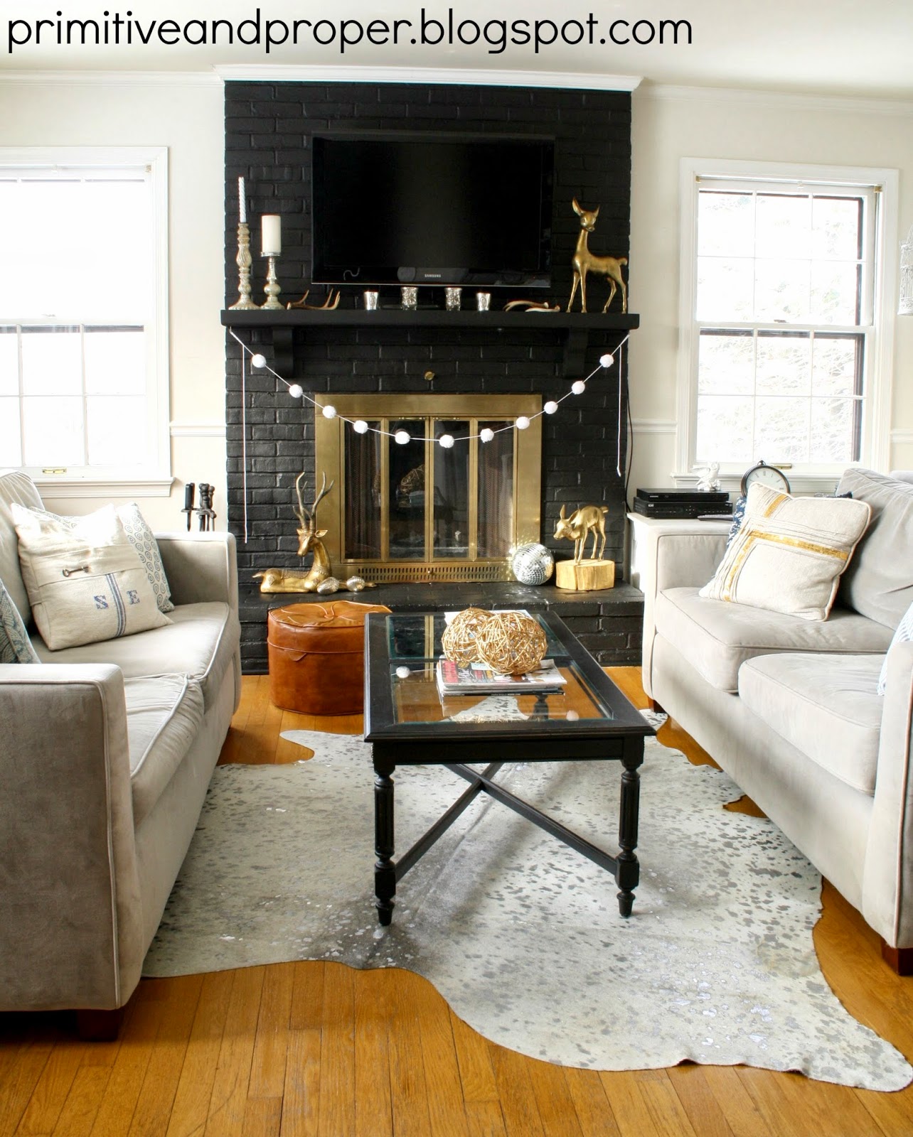 Dramatic Lamp Black Fireplace Makeover & Cowhide Rug from Rugs USA