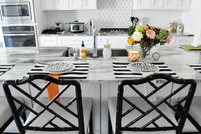 A review of the Dayna counter stools from Ballard Designs in the worn black finish. They look beautiful in this white and chrome glam kitchen. | via monicawantsit.com