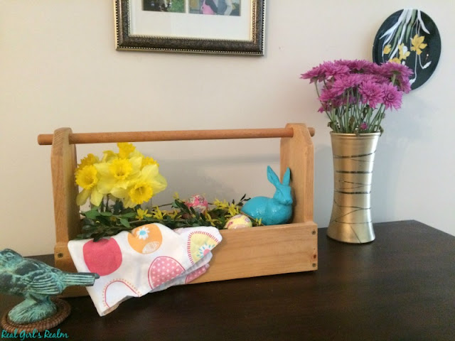 Use Dollar store finds and items from around the house to create a wooden toolbox centerpiece for your Easter decor.