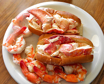 Plate with two lobster rolls and six large shrimp