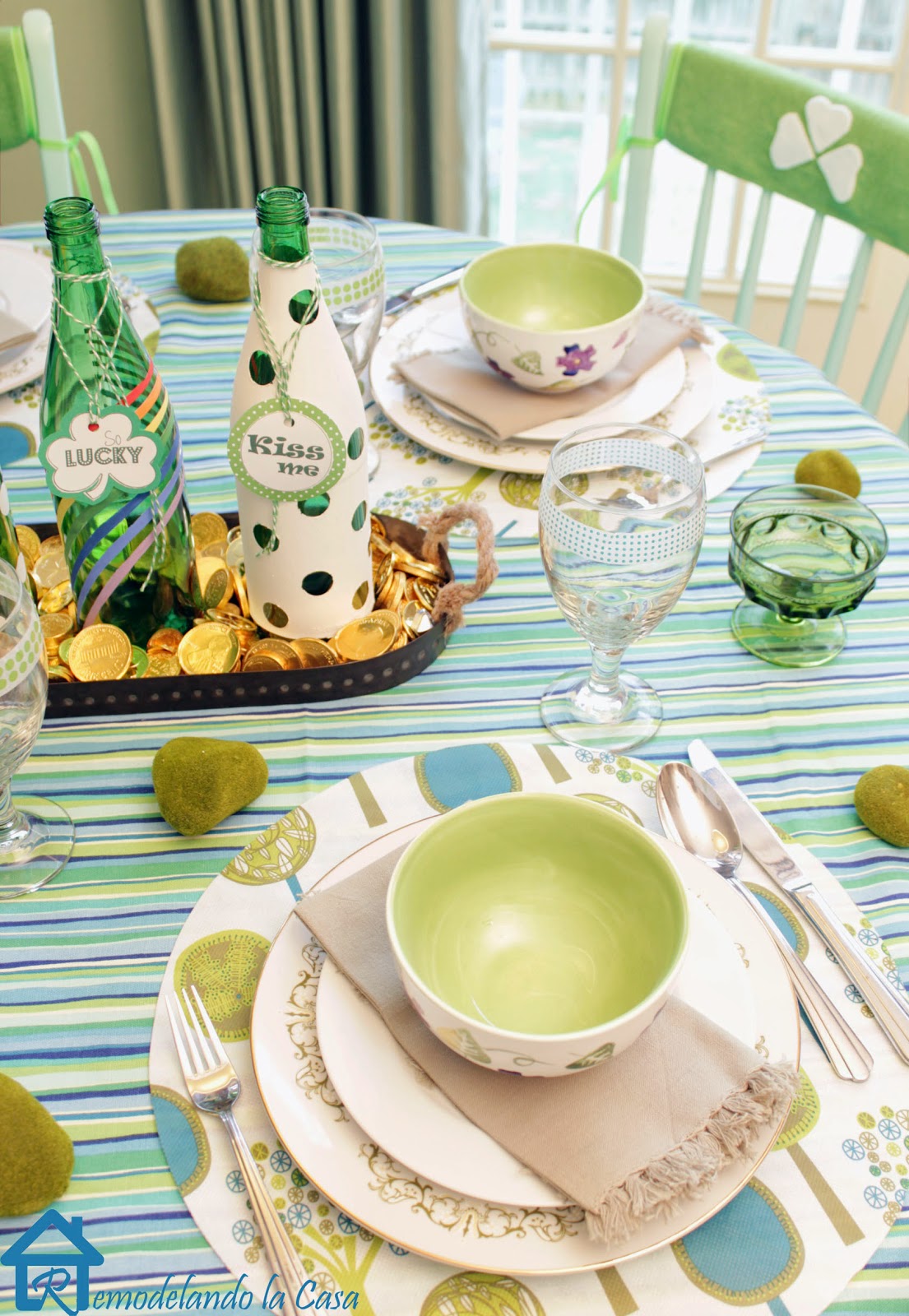 Green bottle centerpiece, plates and chair covers adorn a St. Paddy's table
