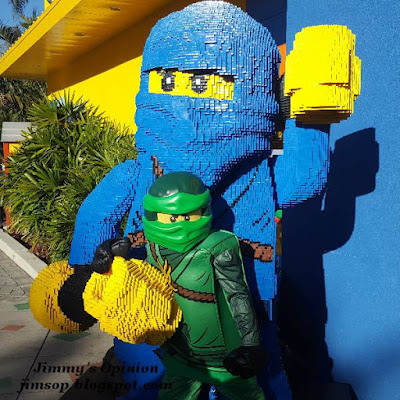 Benjamin dressed as Lloyd posing with a character made from Legos Benjamin dressed as Lego character Lloyd posing with a character made completely from Legos