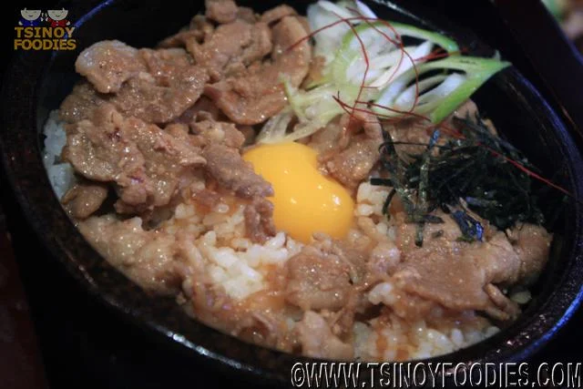 pork rice with egg yolk in stone pot